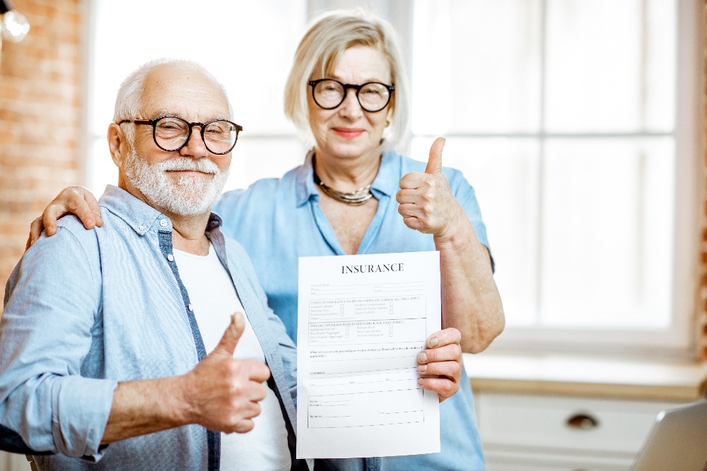 happy-senior-couple-with-insurance-document-2021-10-14-17-45-23-utc-1