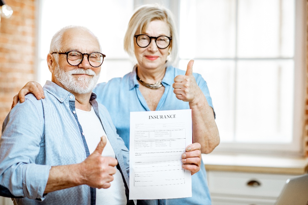 happy-senior-couple-with-insurance-document-2021-10-14-17-45-23-utc-1 happy-senior-couple-with-insurance-document-2021-10-14-17-45-23-utc-1
