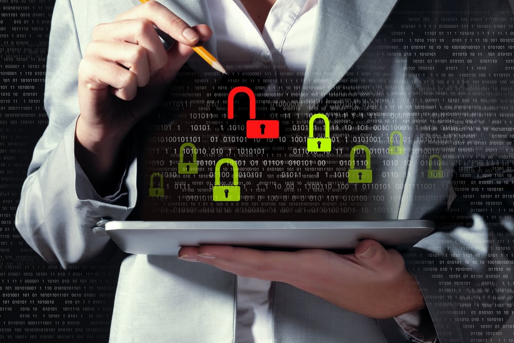 Businesswoman holding tablet pc entering password. Security concept Businesswoman holding tablet pc entering password. Security concept