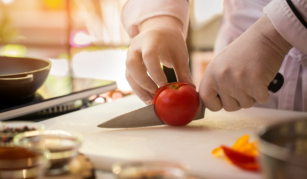 hand-with-knife-cuts-tomato-2021-08-30-08-27-38-utc-1